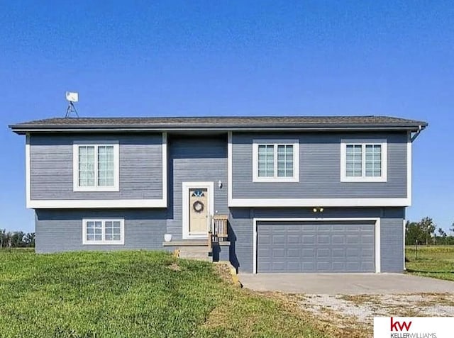 60050 Karns Rd, Pacific Junction, IA 51561 - bi-level home featuring a garage, concrete driveway, a front lawn, entry steps, and brick siding