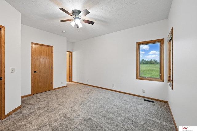 60050 Karns Rd, Pacific Junction, IA 51561 - unfurnished bedroom featuring carpet, baseboards, and ceiling fan