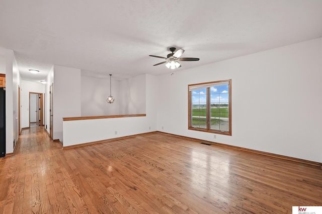 60050 Karns Rd, Pacific Junction, IA 51561 - spare room featuring light wood finished floors, a ceiling fan, and baseboards