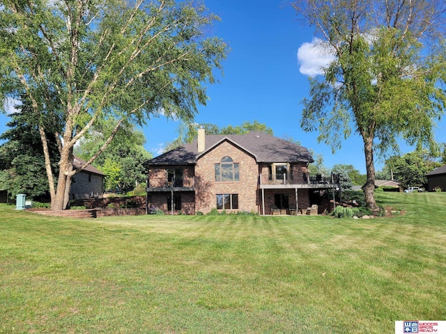 1313 N 8th St, Seward, NE 68434 - back of property with brick siding, a chimney, and a yard