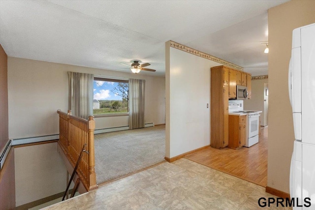 kitchen with white range with electric stovetop, stainless steel microwave, light floors, ceiling fan, and baseboards