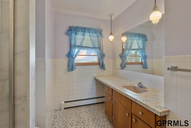 bathroom featuring a baseboard radiator, tile walls, vanity, and a wainscoted wall