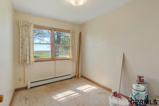 spare room with a baseboard radiator and baseboards