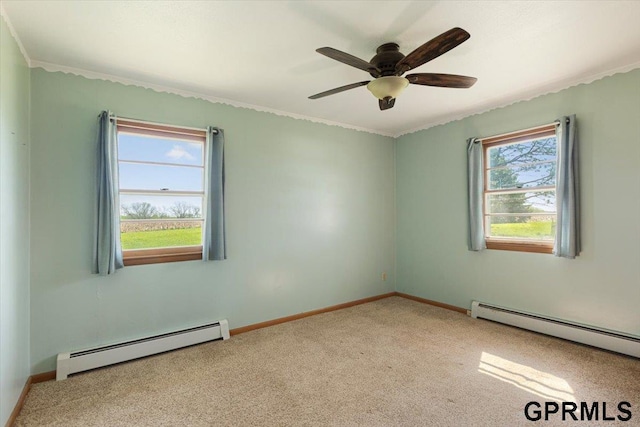 carpeted spare room with a baseboard radiator, baseboards, ornamental molding, and ceiling fan