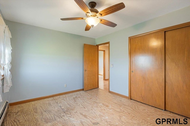 unfurnished bedroom featuring a closet, a baseboard radiator, baseboards, and a ceiling fan