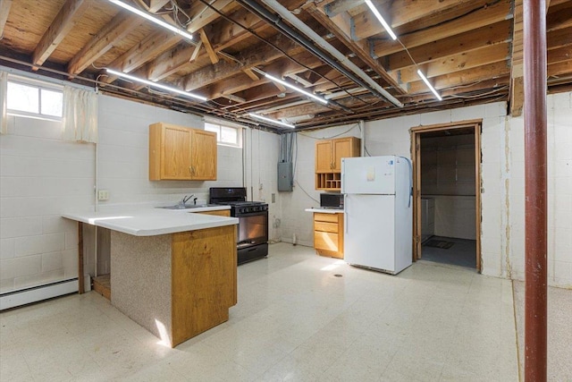 basement with freestanding refrigerator, light flooring, electric panel, a baseboard radiator, and a sink
