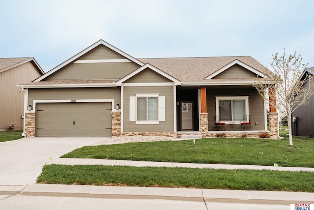 7202 N 167th Ave, Bennington, NE 68007 - craftsman-style home featuring a porch, a front yard, concrete driveway, stone siding, and a garage