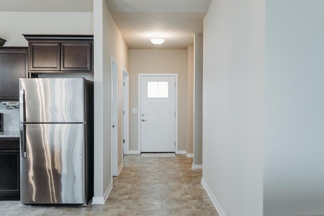7202 N 167th Ave, Bennington, NE 68007 - kitchen with freestanding refrigerator, dark brown cabinets, baseboards, and light countertops