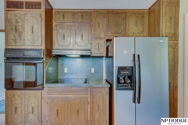 2352 Lincoln St, Blair, NE 68008 - kitchen featuring black appliances, under cabinet range hood, backsplash, and brown cabinets