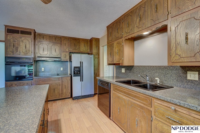 2352 Lincoln St, Blair, NE 68008 - kitchen featuring black appliances, a sink, ventilation hood, tasteful backsplash, and light wood-style flooring