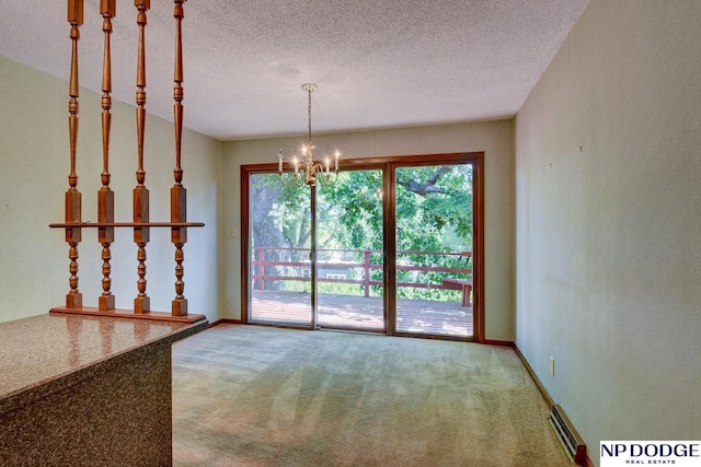 2352 Lincoln St, Blair, NE 68008 - unfurnished dining area featuring a chandelier, carpet, a textured ceiling, and baseboards