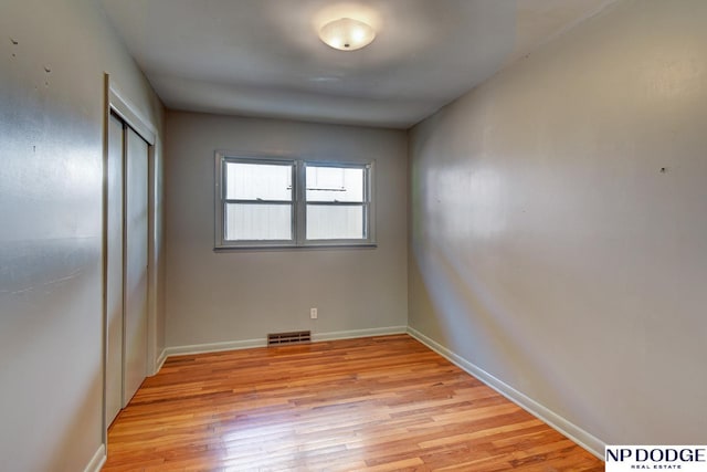 2352 Lincoln St, Blair, NE 68008 - unfurnished bedroom with light wood-type flooring, a closet, and baseboards