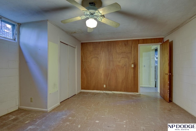 2352 Lincoln St, Blair, NE 68008 - empty room with crown molding, a ceiling fan, and wooden walls