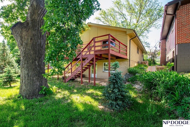 2352 Lincoln St, Blair, NE 68008 - back of house featuring a deck, stairs, and brick siding