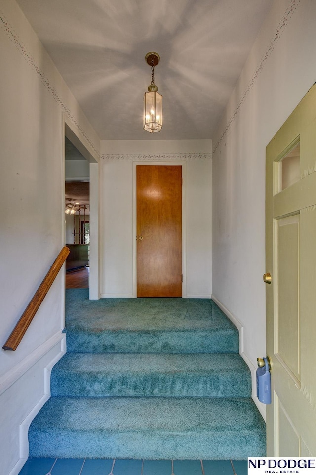2352 Lincoln St, Blair, NE 68008 - stairway featuring carpet and a chandelier