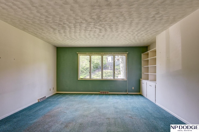 2352 Lincoln St, Blair, NE 68008 - empty room with carpet floors, baseboards, and a textured ceiling