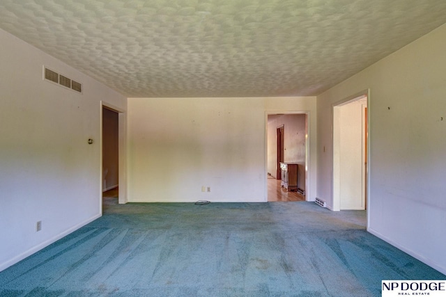 2352 Lincoln St, Blair, NE 68008 - carpeted spare room with baseboards and a textured ceiling