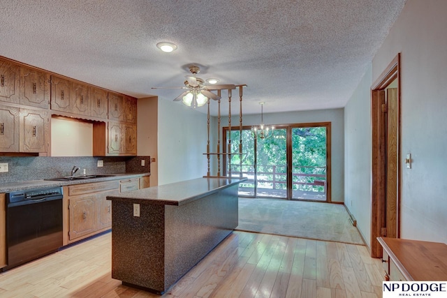 2352 Lincoln St, Blair, NE 68008 - kitchen with dishwasher, light wood-style floors, ceiling fan, backsplash, and a textured ceiling
