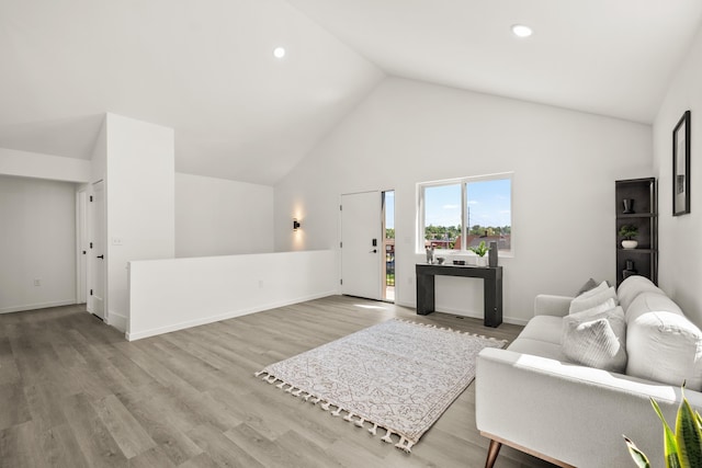 living room with wood finished floors, recessed lighting, baseboards, and high vaulted ceiling