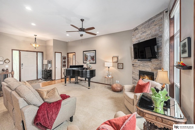 2705 N 189th St, Omaha, NE 68022 - living room featuring a stone fireplace, ceiling fan, recessed lighting, baseboards, and carpet