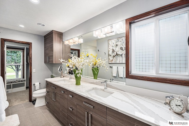 2705 N 189th St, Omaha, NE 68022 - full bath featuring toilet, double vanity, recessed lighting, tile patterned floors, and a chandelier