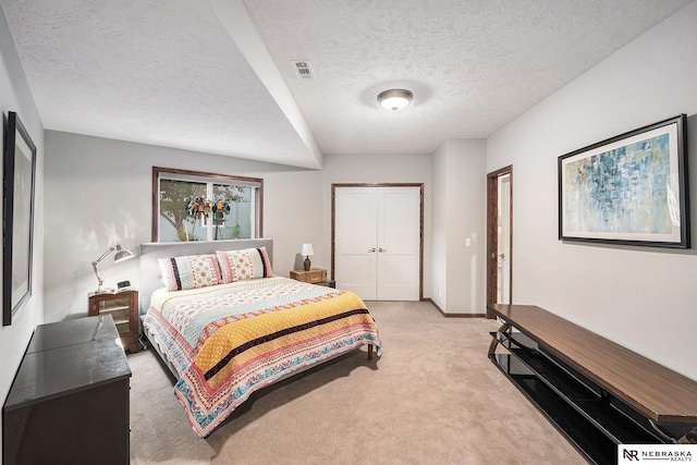 2705 N 189th St, Omaha, NE 68022 - bedroom with light carpet, a closet, a textured ceiling, and baseboards