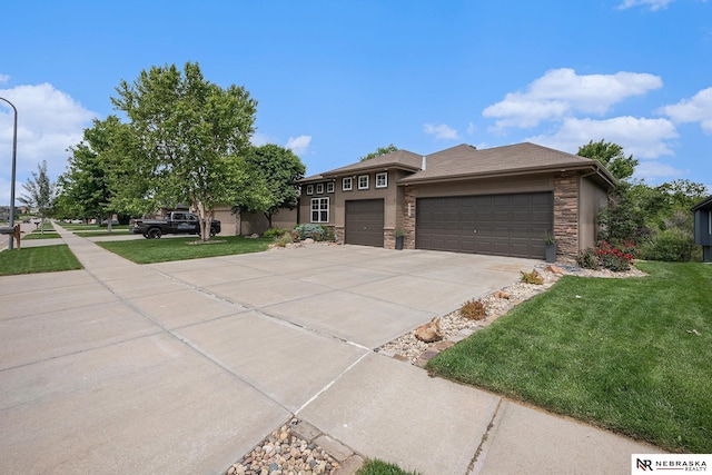2705 N 189th St, Omaha, NE 68022 - prairie-style home with stone siding, a front yard, an attached garage, and driveway