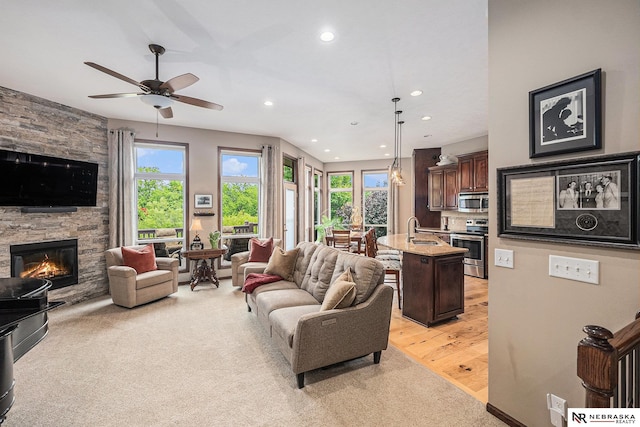 2705 N 189th St, Omaha, NE 68022 - living area with recessed lighting, a fireplace, a ceiling fan, and light wood-style flooring