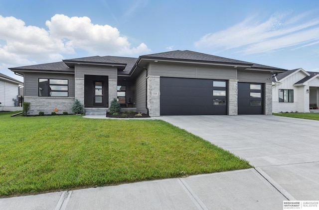 5508 N 208th St, Elkhorn, NE 68022 - prairie-style home with a garage, concrete driveway, stone siding, a front lawn, and roof with shingles