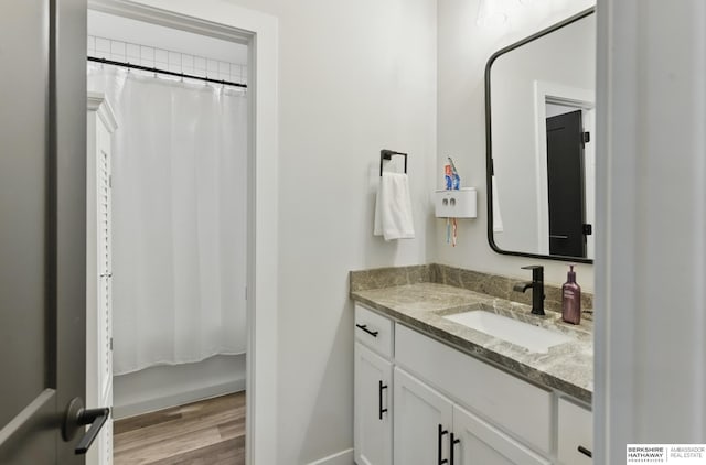 5508 N 208th St, Elkhorn, NE 68022 - bathroom featuring wood finished floors, vanity, a shower with shower curtain, and baseboards