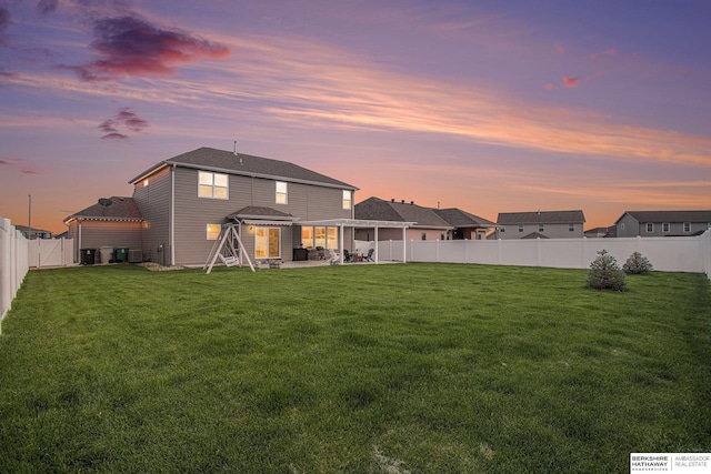 17176 Summit St, Bennington, NE 68007 - back of house at dusk featuring a patio