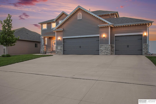 17176 Summit St, Bennington, NE 68007 - view of front facade featuring an attached garage, stone siding, and driveway