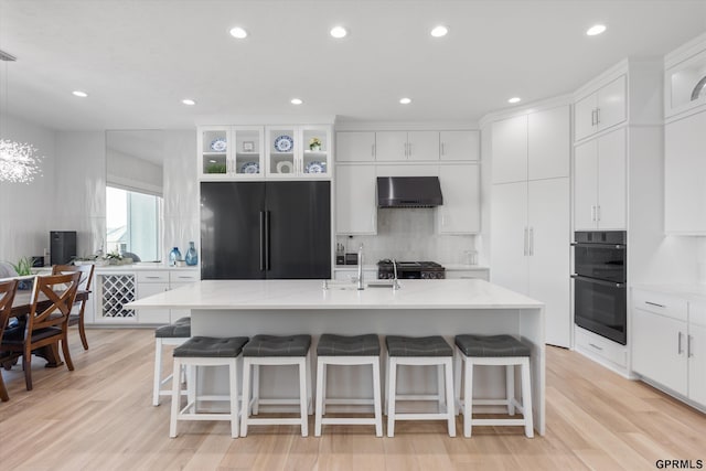12604 N 178th Cir, Bennington, NE 68007 - kitchen featuring black appliances, exhaust hood, light wood-type flooring, white cabinetry, and recessed lighting