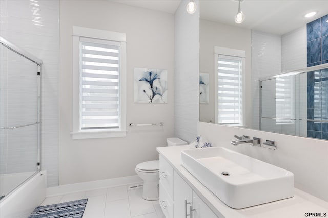 12604 N 178th Cir, Bennington, NE 68007 - bathroom with tile patterned floors, toilet, baseboards, vanity, and bath / shower combo with glass door