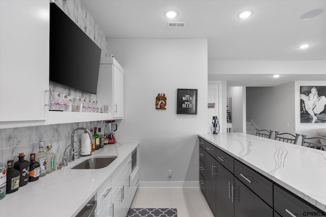 12604 N 178th Cir, Bennington, NE 68007 - kitchen with a sink, baseboards, light stone countertops, backsplash, and recessed lighting