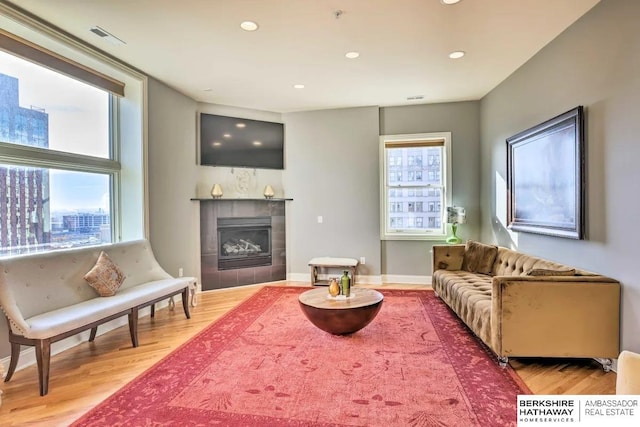 210 S 16th St S Unit 918, Omaha, NE 68102 - living area featuring light wood-style floors, plenty of natural light, a tiled fireplace, and recessed lighting