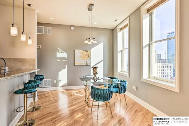 210 S 16th St S Unit 918, Omaha, NE 68102 - dining space with light wood-style flooring and baseboards