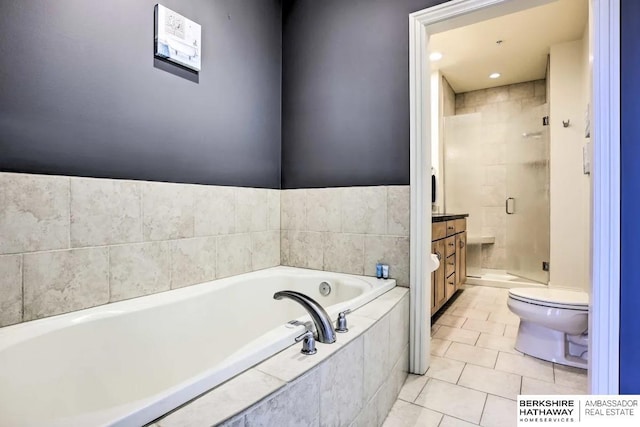 210 S 16th St S Unit 918, Omaha, NE 68102 - bathroom with toilet, vanity, a stall shower, a garden tub, and tile patterned flooring