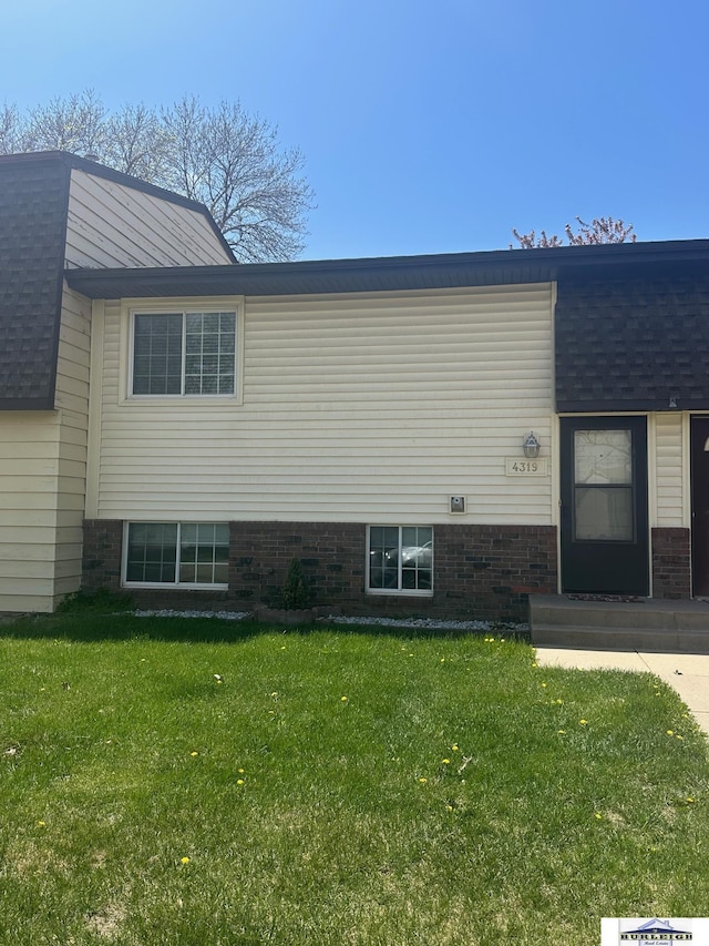 4319 Abbott Rd, Lincoln, NE 68516 - view of home's exterior with a lawn and roof with shingles