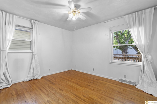 14618 Holmes St, Omaha, NE 68137 - unfurnished room with wood finished floors, ceiling fan, and baseboards
