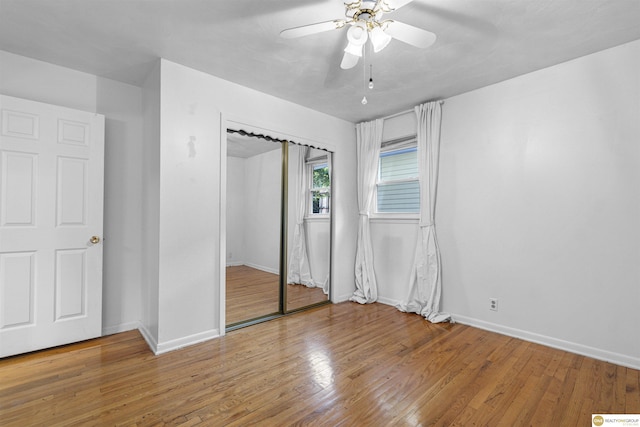 14618 Holmes St, Omaha, NE 68137 - unfurnished bedroom with baseboards, wood finished floors, and a closet