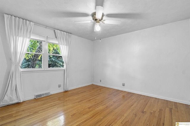 14618 Holmes St, Omaha, NE 68137 - unfurnished room with light wood finished floors, a ceiling fan, and baseboards