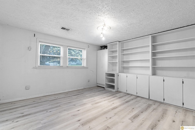 14618 Holmes St, Omaha, NE 68137 - unfurnished bedroom with light wood finished floors and a textured ceiling