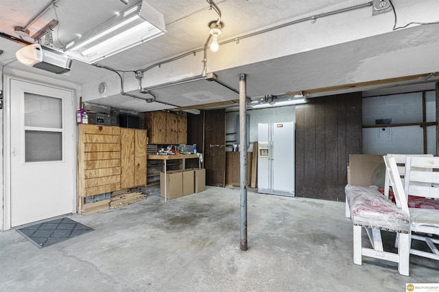 14618 Holmes St, Omaha, NE 68137 - below grade area featuring white fridge with ice dispenser and a workshop area