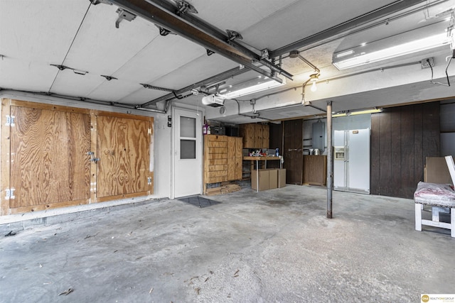 14618 Holmes St, Omaha, NE 68137 - garage featuring a garage door opener, white refrigerator with ice dispenser, and electric panel