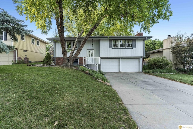 14618 Holmes St, Omaha, NE 68137 - bi-level home featuring an attached garage, a front lawn, concrete driveway, and a chimney
