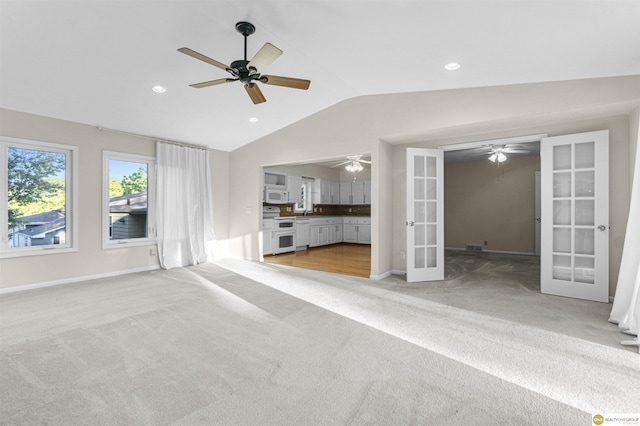 14618 Holmes St, Omaha, NE 68137 - unfurnished living room with french doors, light carpet, vaulted ceiling, ceiling fan, and baseboards