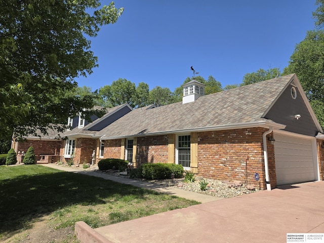 1924 W 8th Ave, Plattsmouth, NE 68048 - view of front of property featuring brick siding, driveway, a front lawn, a shingled roof, and a chimney
