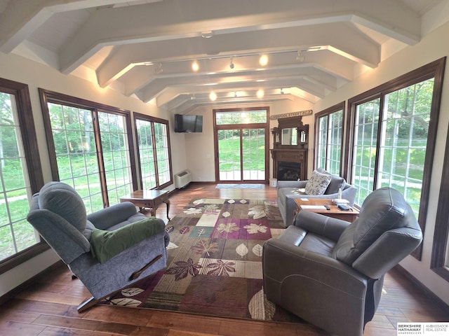 1924 W 8th Ave, Plattsmouth, NE 68048 - sunroom featuring wood finished floors, baseboards, rail lighting, and a wall unit AC