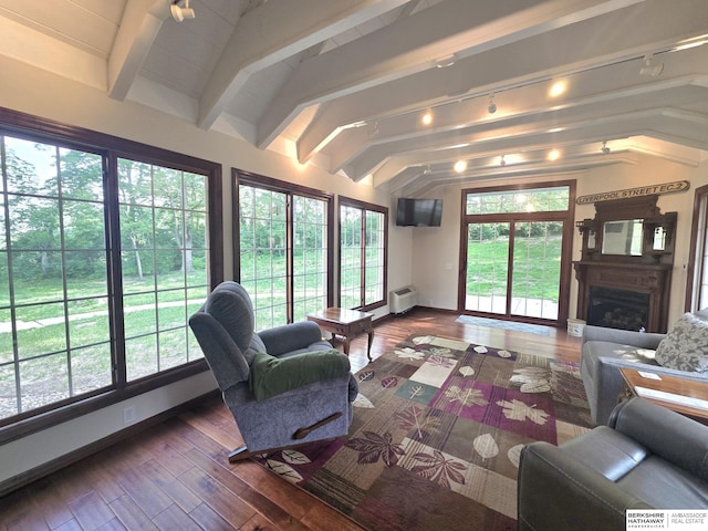 1924 W 8th Ave, Plattsmouth, NE 68048 - living room featuring a fireplace, baseboards, wood-type flooring, and a wall mounted AC